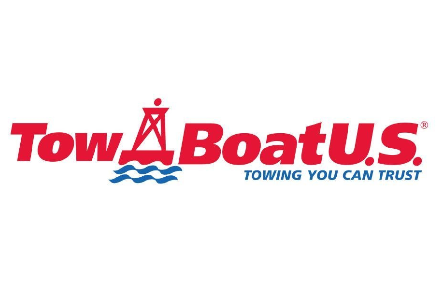 Logo of Tow Boat U.S. with red text, a red lighthouse, blue water waves, and the slogan "Towing You Can Trust" in blue.