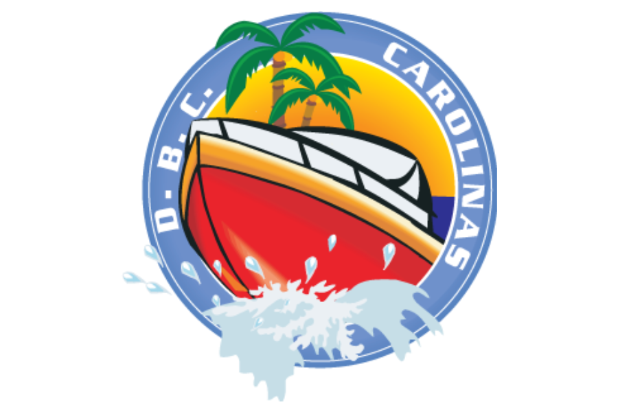 A logo featuring a red and white boat with yellow accents, surrounded by a blue circular border with the words 'D.B.C.' and 'CAROLINAS', with palm trees and a sunset in the background.