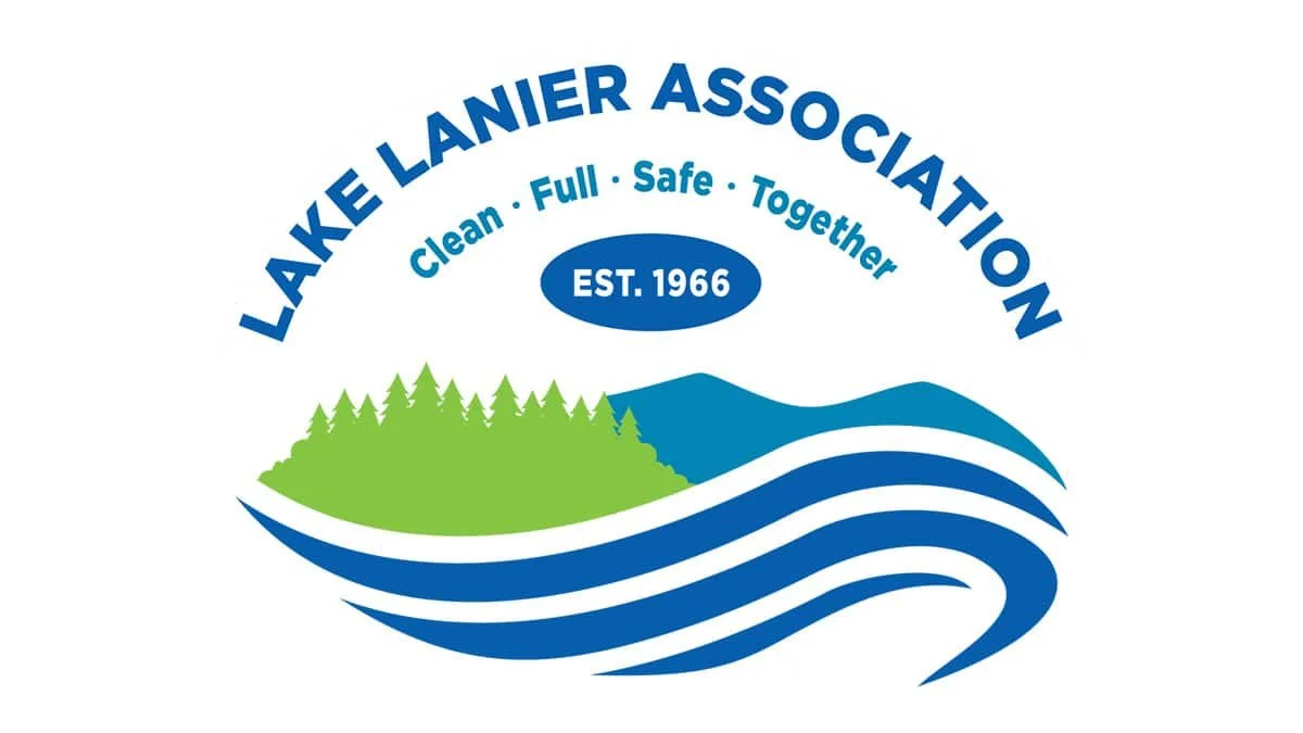 Logo for Lake Lanier Association featuring a green tree and blue waves, with the words 'Lake Lanier Association,' 'EST. 1966,' and the slogans 'Clean, Fun, Safe, Together'.