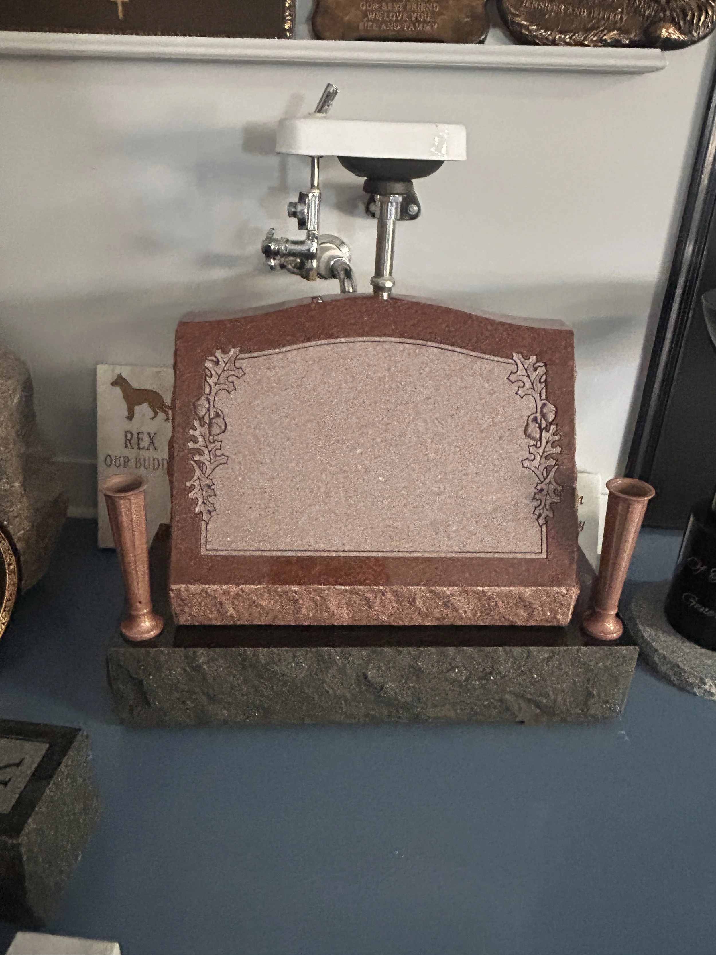 a red-toned gravestone in the Lough Memorials showroom