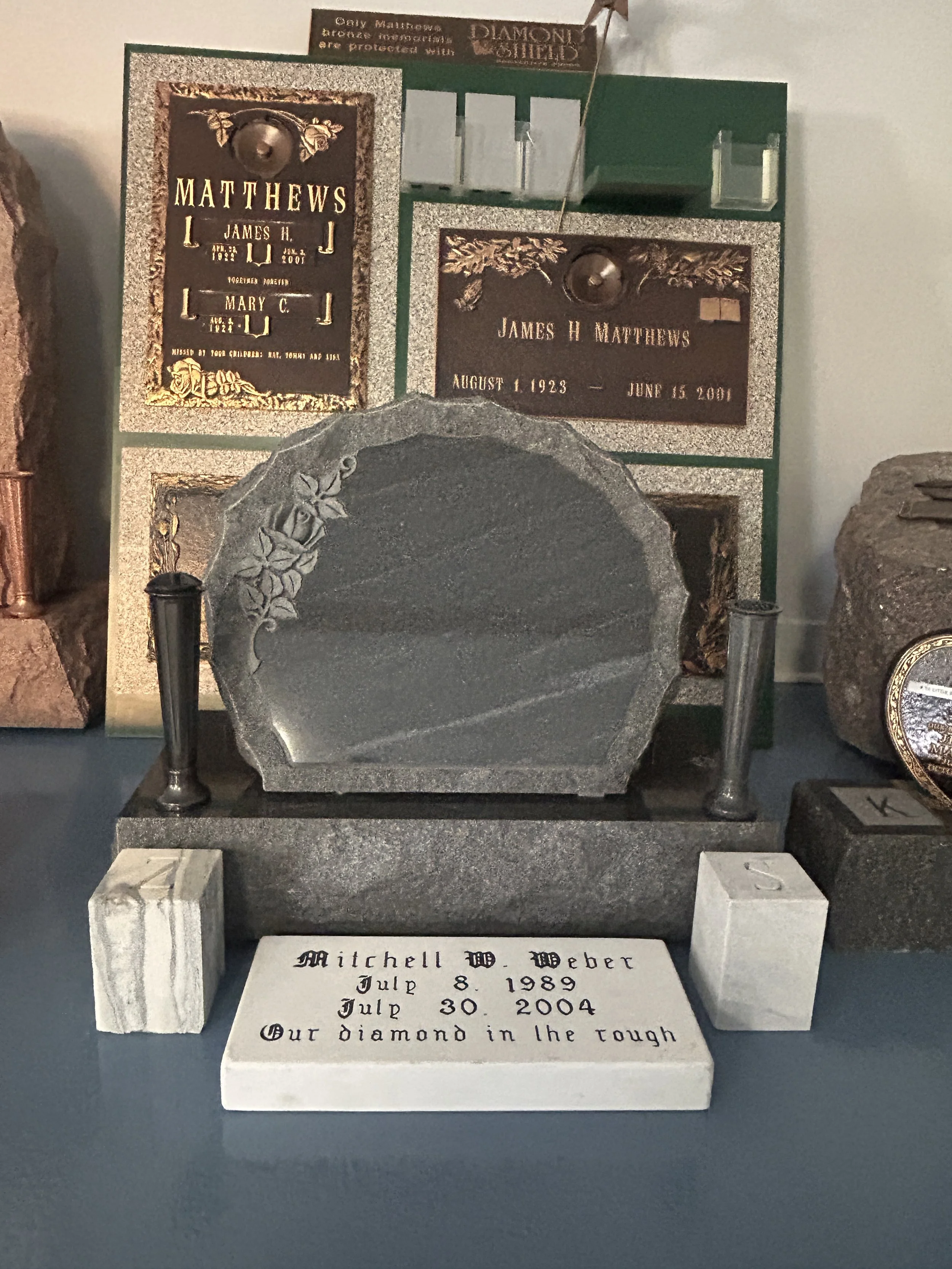 A memorial monument with engraved plaques decorated with floral designs