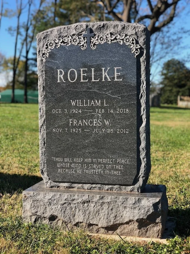 A gravestone with the surname Roelke, engraved with the names William L. (1924-2018) and Frances W. (1925-2012), and a quote at the bottom.