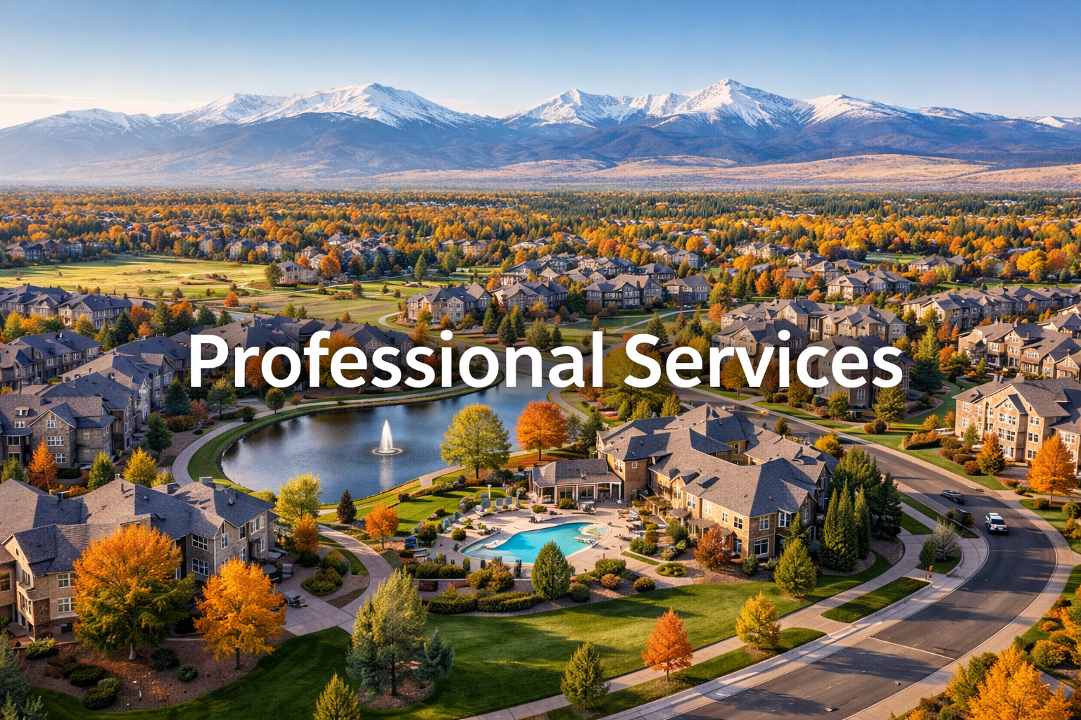 A suburban neighborhood with houses, a lake with a fountain, a swimming pool, and a backdrop of snow-capped mountains during fall.