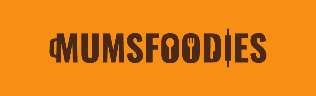 Logo with the text 'MUMSFOODIES' on an orange background, with the letter 'O' replaced by a fork and knife icon.