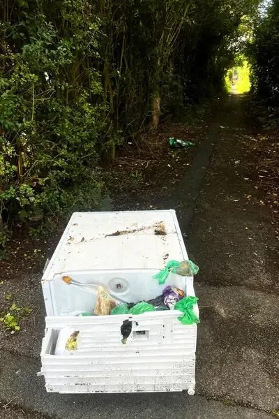 flytipped washing machine with dog poo bags