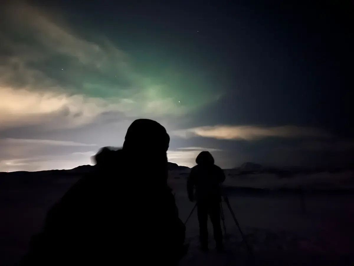 Copyright Knot Waste: Iceland, Northern Lights - Your camera or phone has to be completely still to capture the lights; our tour guide using a tripod in the distance. 