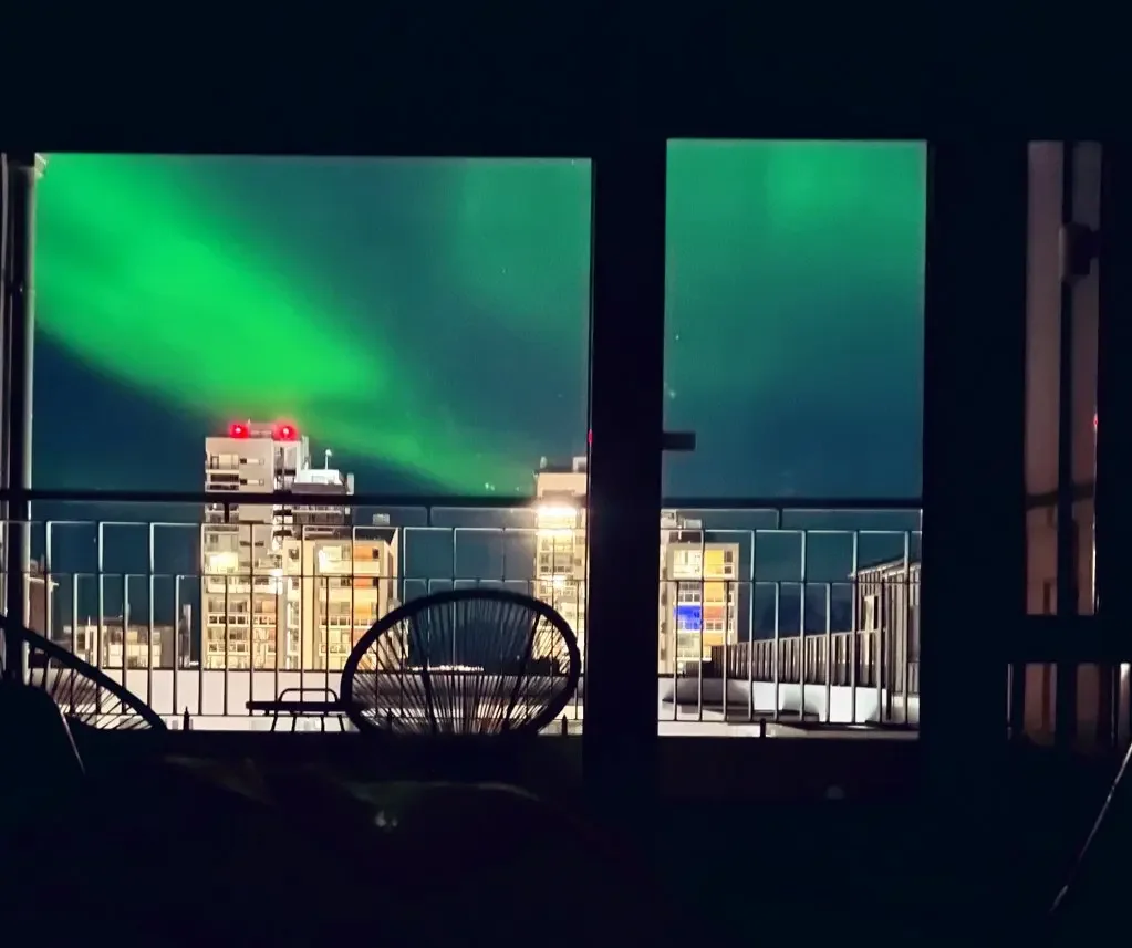 Copyright Knot Waste: Iceland, Northern Lights illuminate the apartment's balcony.