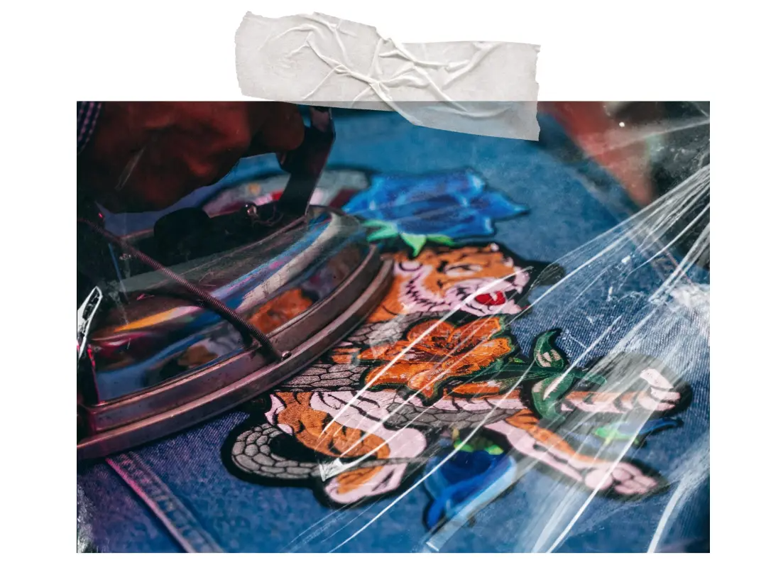Embroidered tiger is ironed on a denim jacket.