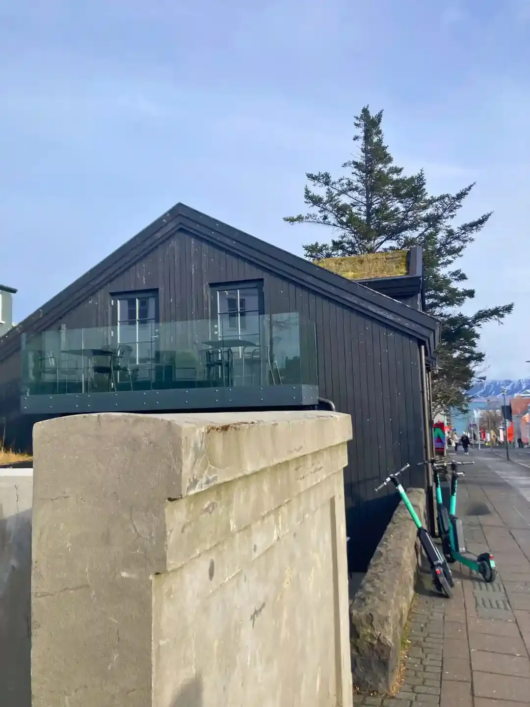 Copyright Knot Waste: Reykjavik, Iceland: Electric scooters left by a house. Scooter sharing is available with apps such as Bolt or Hopp. 