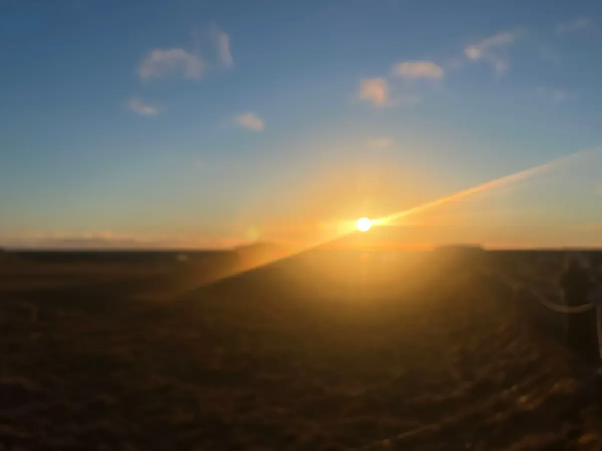 Copyright Knot Waste: Southern Iceland Coach Trip - Snap of the sun setting through the window.
