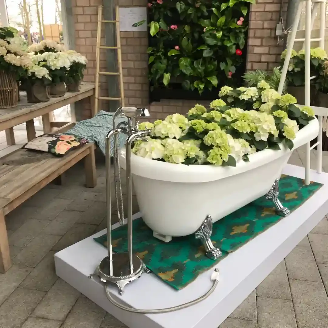 A bathtub filled with yellow and green flowers in a gardening display in Amsterdam.