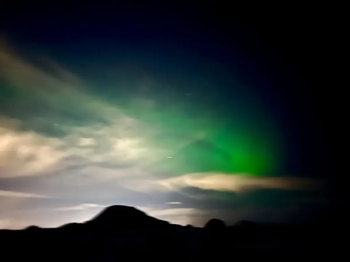 Copyright Knot Waste: Iceland, Northern Lights - Aurora Borealis illuminate the skies about the mountains. 