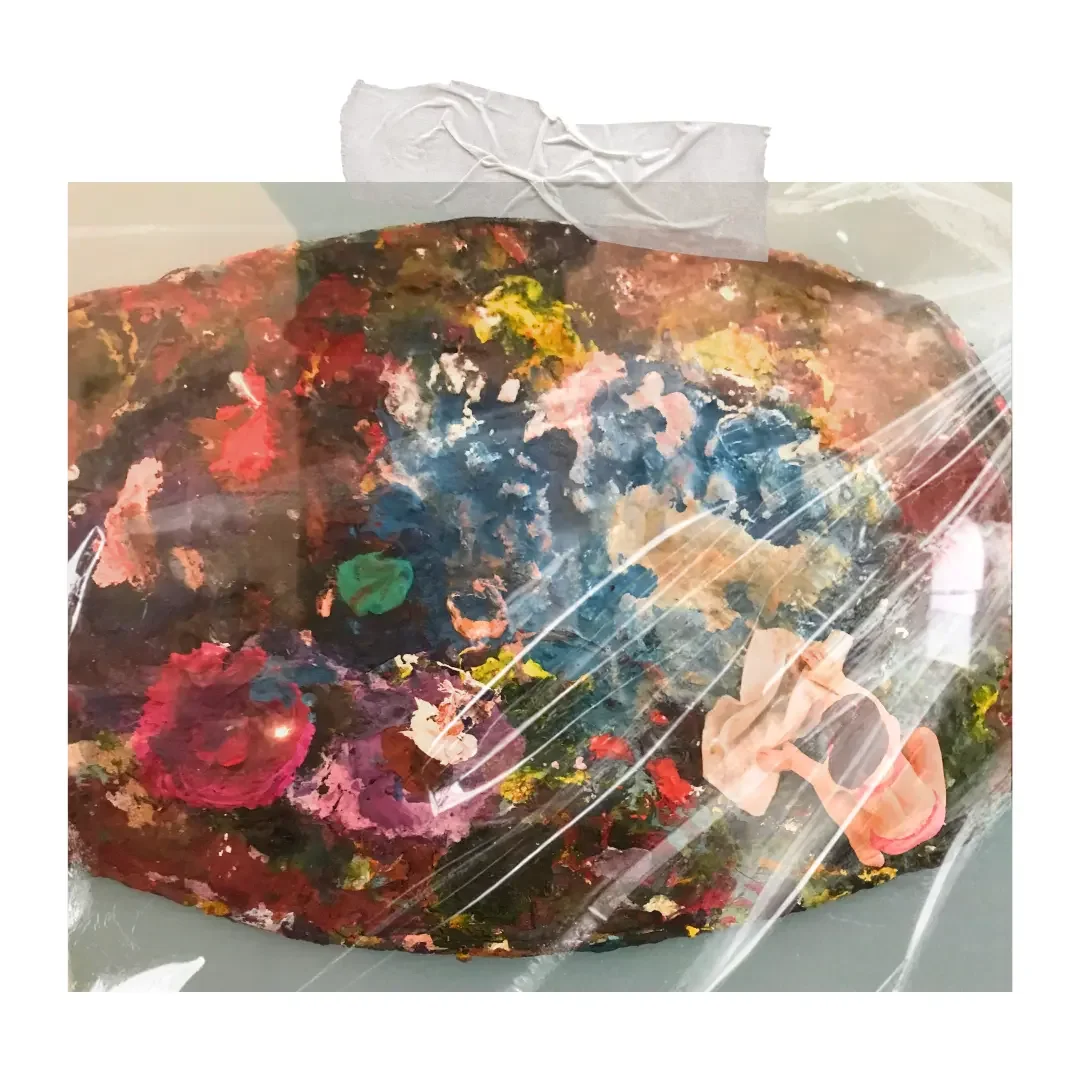 A palette of with a mixture of paint and a Plasticine model.
