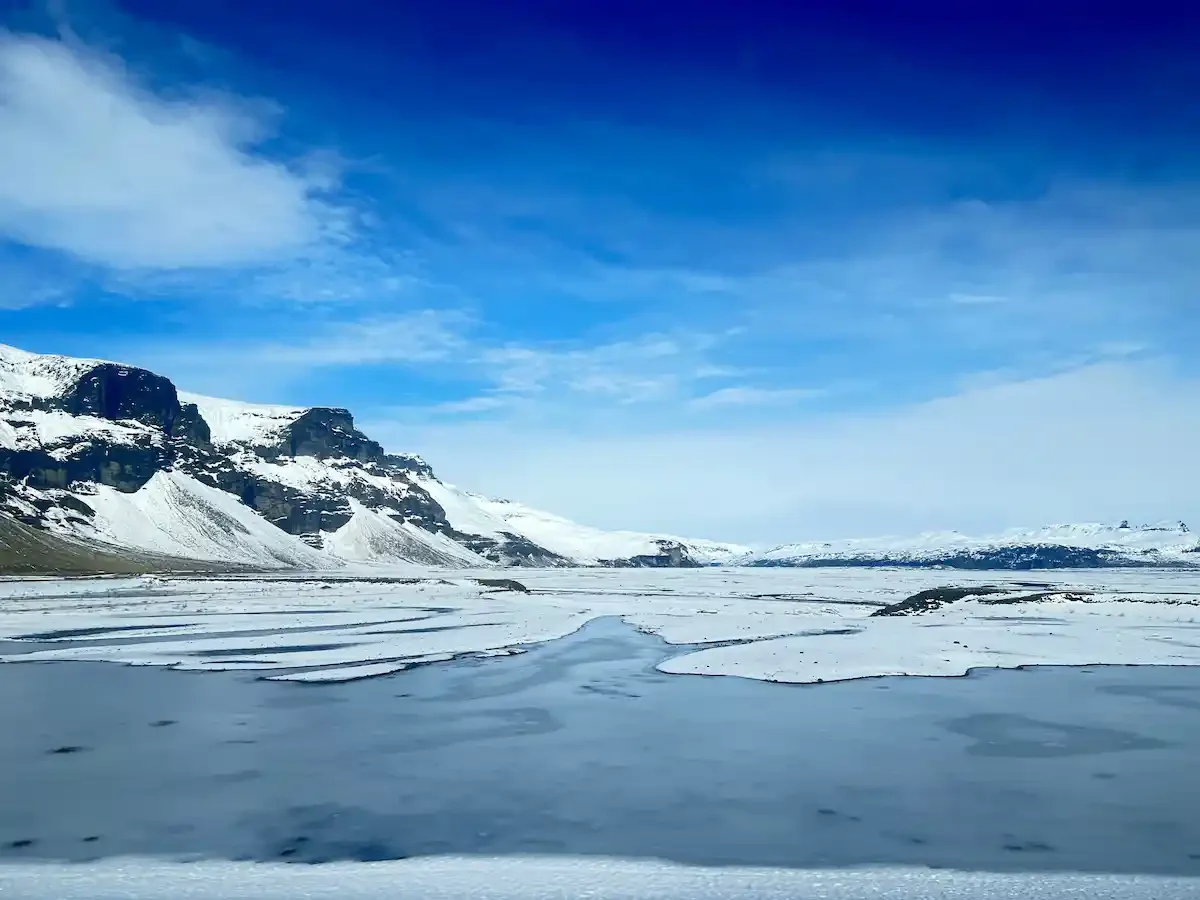 Copyright Knot Waste: Southern Iceland Coach Trip - Snow filled mountains through the window.