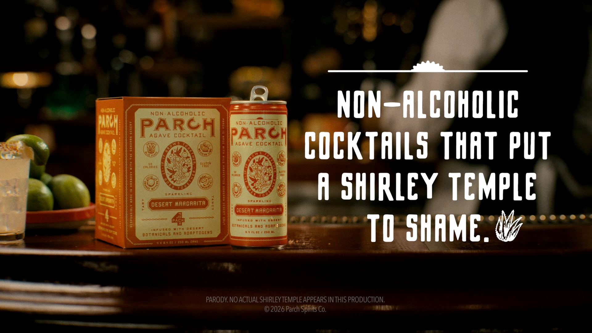 A can of non-alcoholic Parch Agave Cocktail with orange packaging and a transparent glass with limes inside, placed on a bar counter with a dark, blurred background. Overlaid text reads: "Non-alcoholic cocktails that put a Shirley Temple to shame."