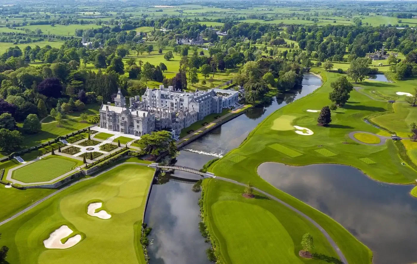 A sweeping aerial view of the historic Adare Manor estate, the River Maigue, and its championship golf course set amidst the lush countryside of County Limerick, Ireland.