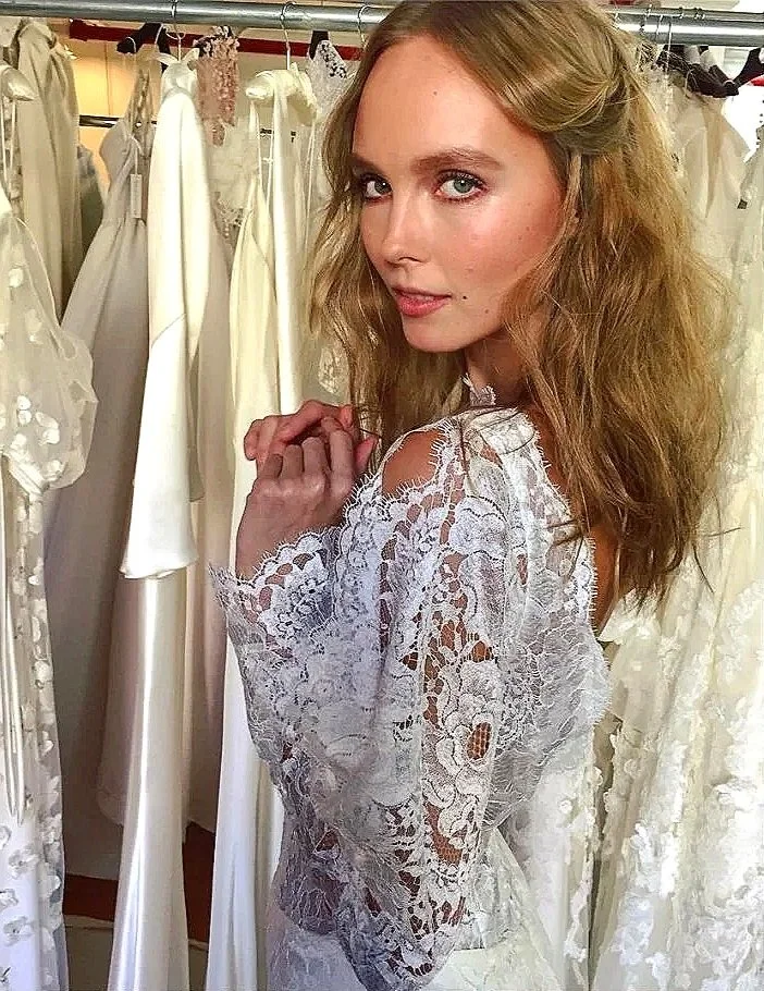 Editorial bridal makeup by Elisa Flowers featuring soft, luminous skin in a lace wedding gown setting