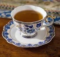 Tea in a blue cup with saucer