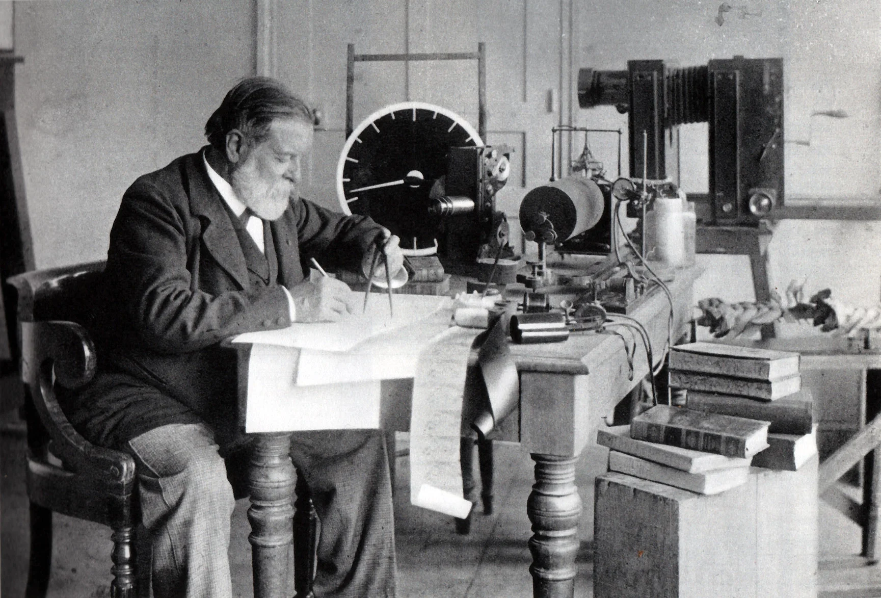 Marey c.1900: scientist at work desk surrounded by chronophotography equipment including cameras and measurement instruments