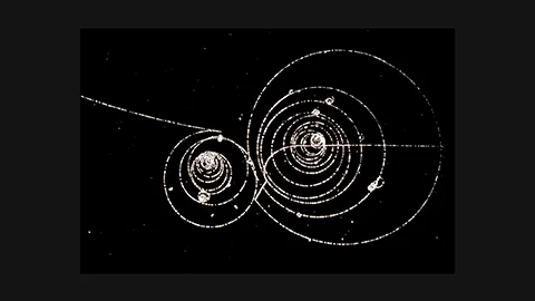 CERN 1973: Subatomic particle tracks in liquid hydrogen bubble chamber – kaon decay and omega production visible as curved bubble trails