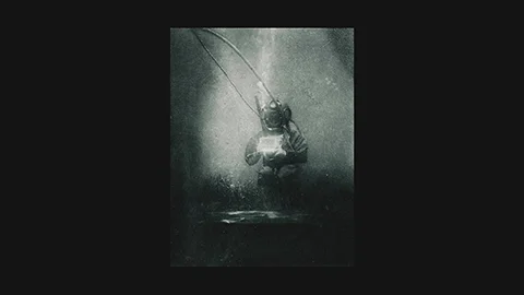 Boutan 1898: diver in helmet suit suspended underwater with tether lines – first photograph with submerged camera and photographer