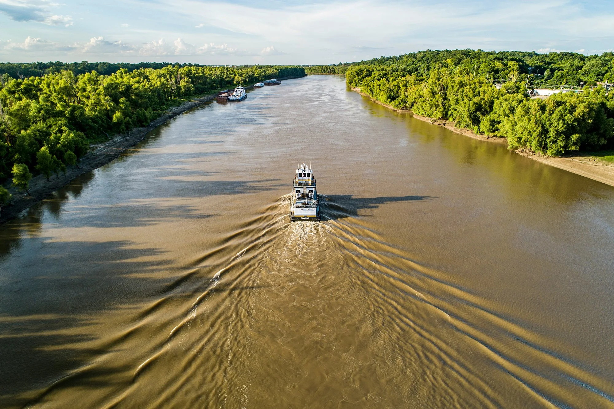 Riverboat going down a brown river
