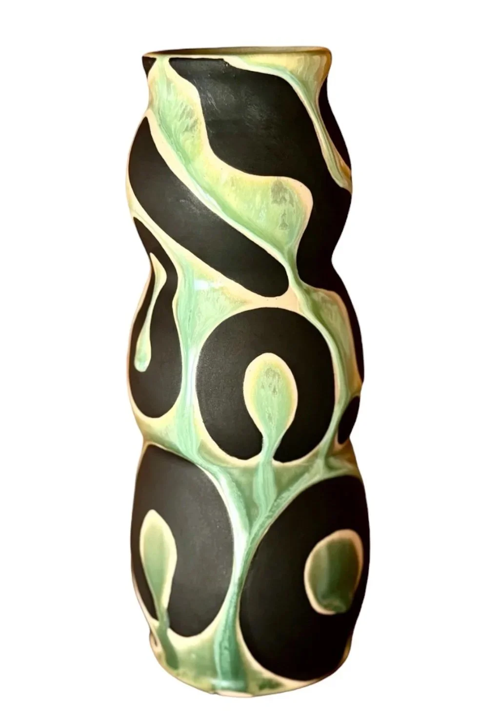 A tall ceramic vase with a black, green, and yellow abstract swirl pattern.
