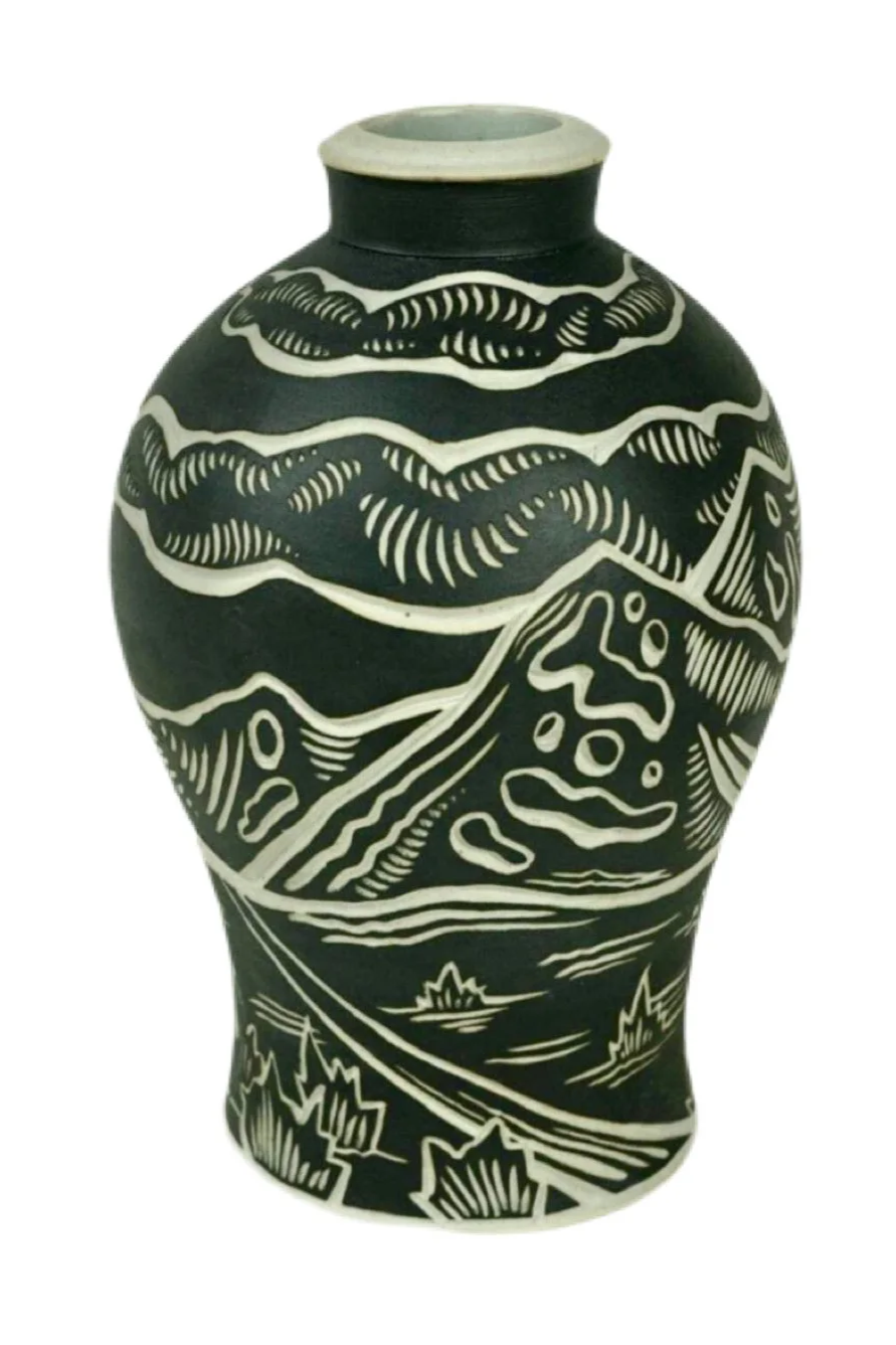 Black ceramic vase with white abstract landscape design including clouds, mountains, and water.