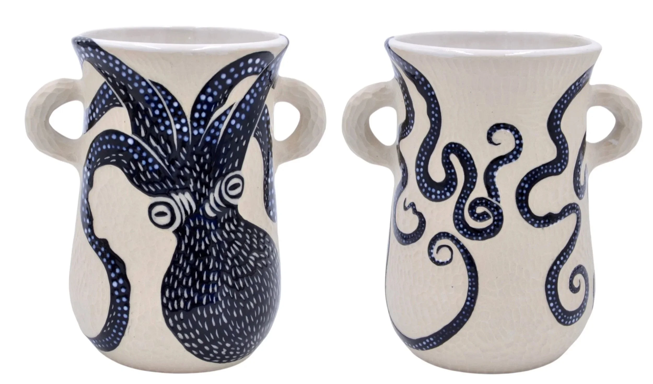 Two ceramic mugs with artistic blue and black designs, each featuring a different abstract pattern on a white background.