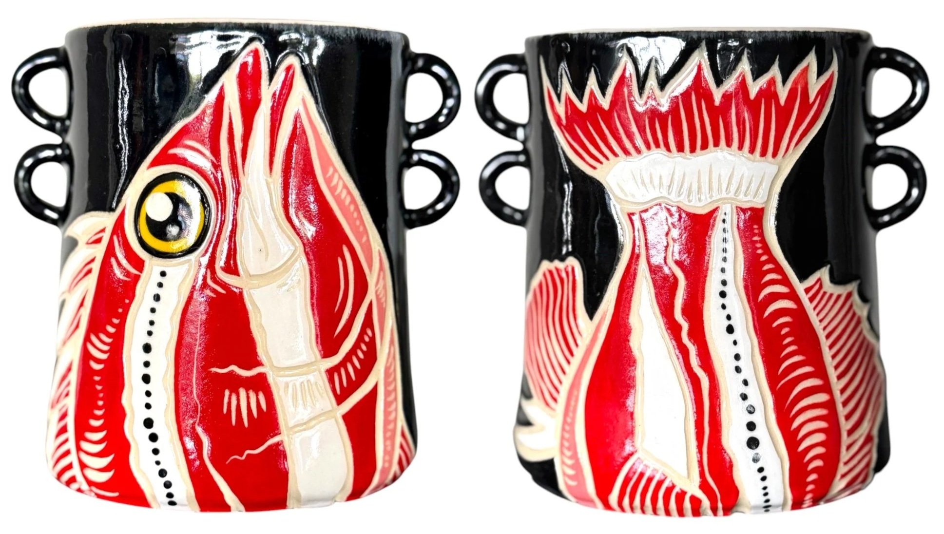 Two ceramic mugs with anatomical heart artwork, featuring red, white, and black colors, side by side.