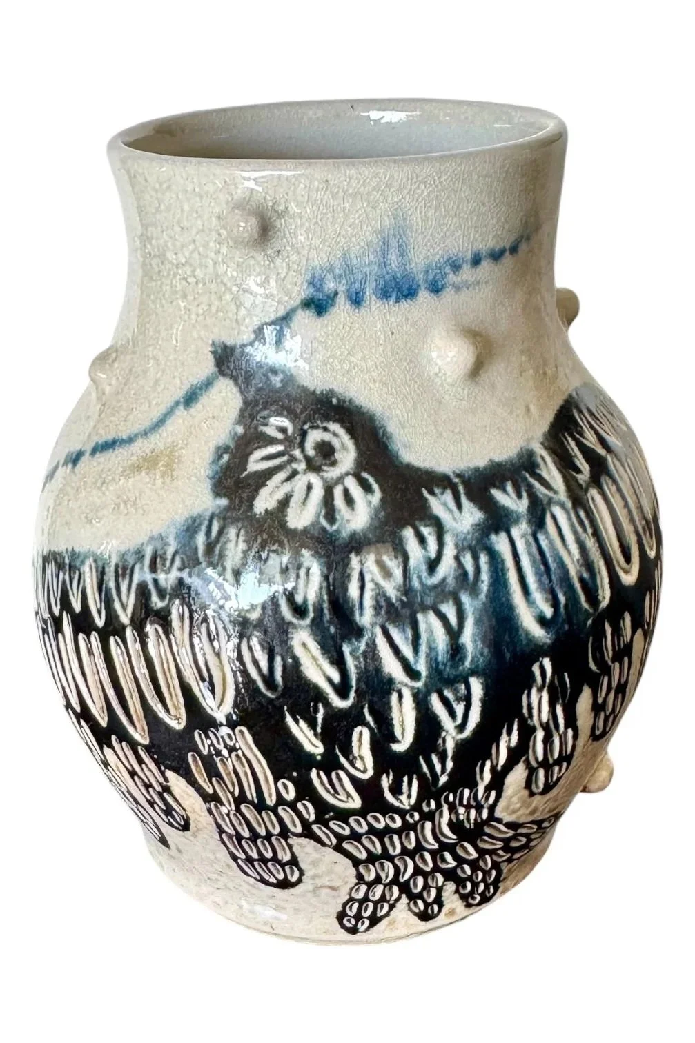 Ceramic vase with black and white bird design and blue accents on a light background.