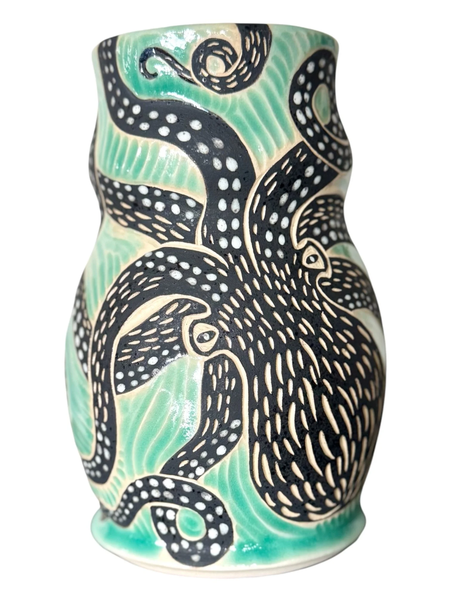 Colorful ceramic vessel with black and white abstract and animal patterns, accented with green and cream motifs.