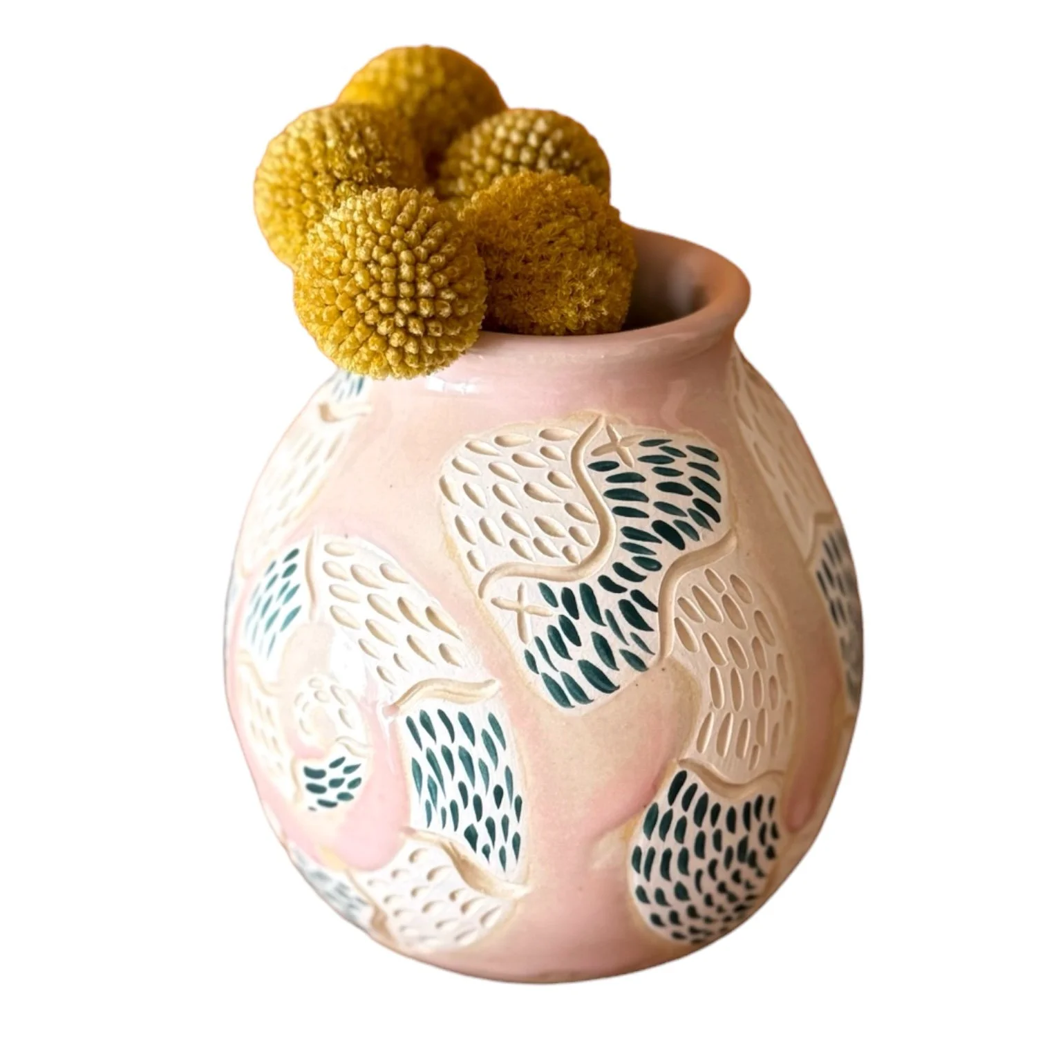 A ceramic vase with a floral pattern, topped with a cluster of yellow gomphrena flowers.