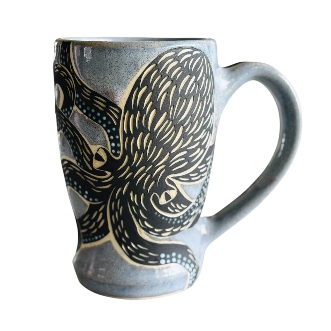 Ceramic mug with black and beige abstract design featuring geometric shapes and lines on a white background.