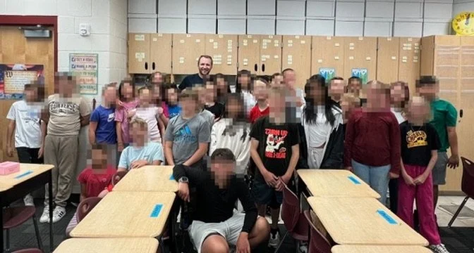 Brett Nielsen posing with a classroom of students in Lehi, Utah