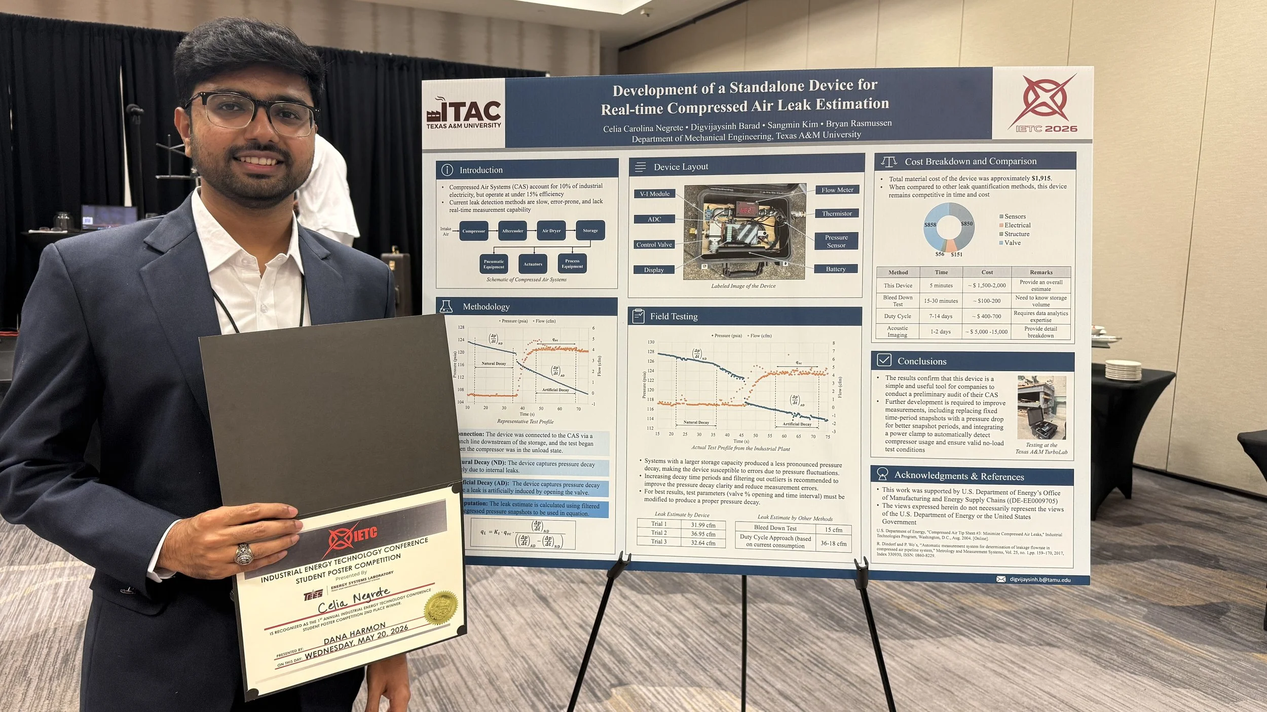 A man standing next to a poster that shows graphs and calculations related to industrial energy technology