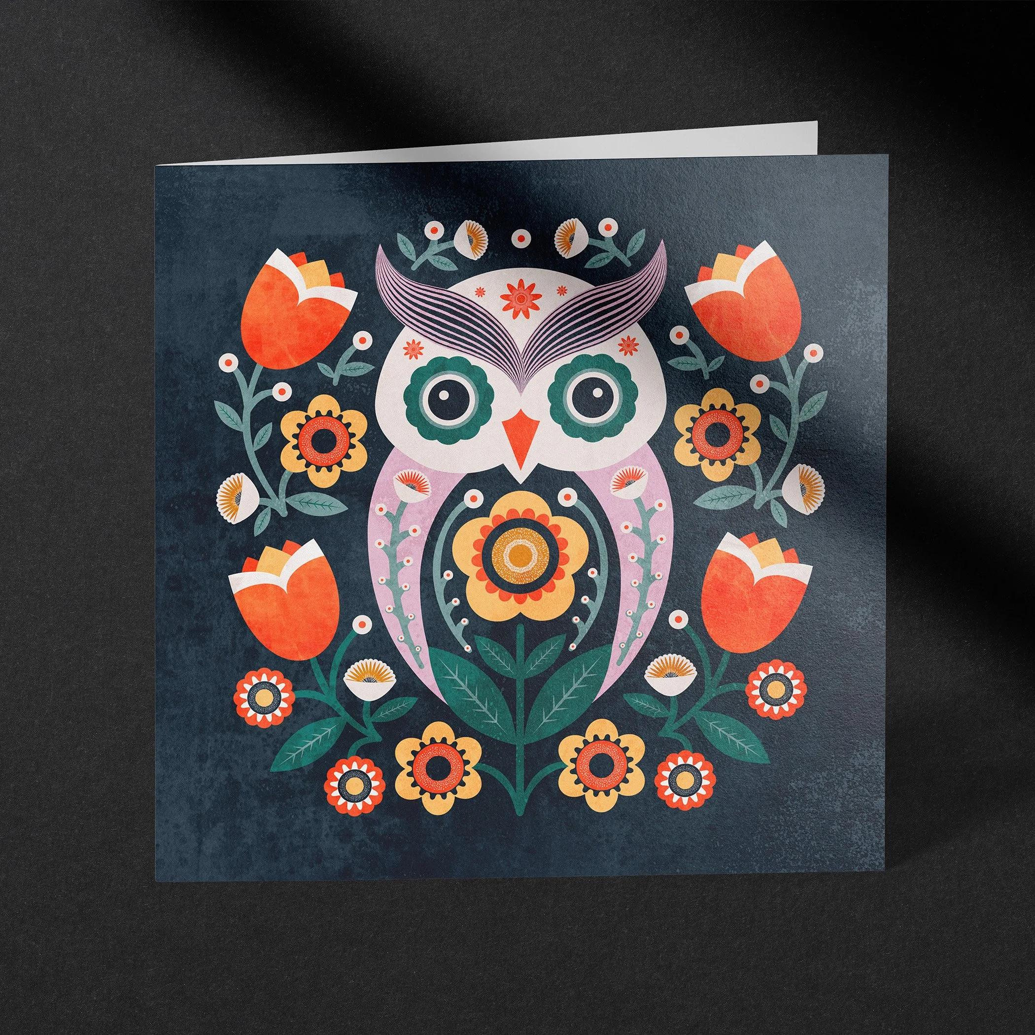 Whimsical owl greeting card with decorative floral folk art illustration in rich colors.