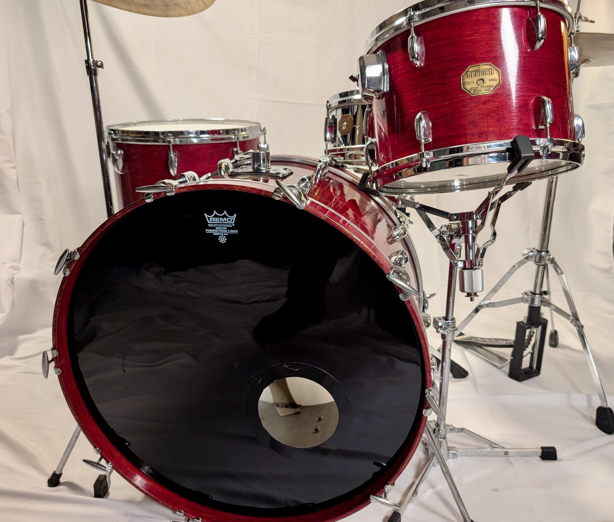 Gretsch cherry 12x24/9x13/16x16/ drum set, stop sign badge, 1970s. The supplied snare drum is a Gretsch 4140, 5.5x14. Chrome over brass, with lightning throw-off.