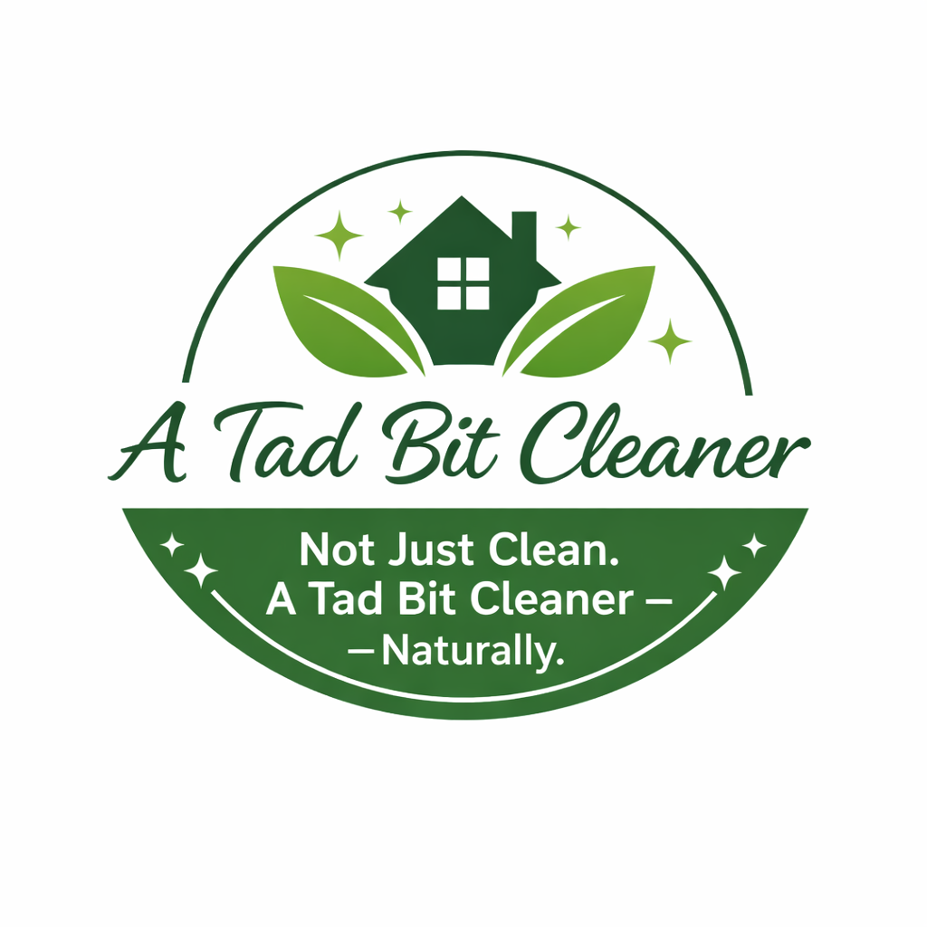 Green circular logo with a house and leaves, reads 'A Tad Bit Cleaner' with the tagline 'Not Just Clean. A Tad Bit Cleaner – Naturally.'