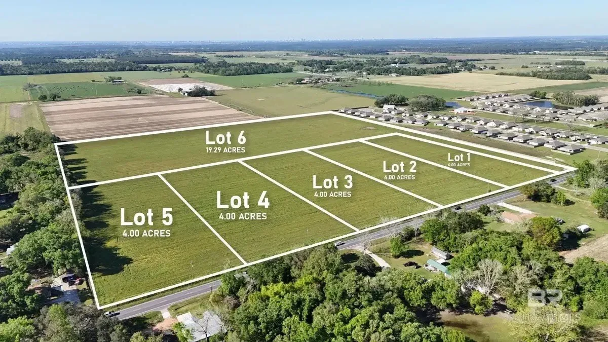 Aerial view of a subdivided land with six lots, each outlined with white lines and labeled with lot numbers and acreage, in a rural area with farmland, trees, and a few houses.