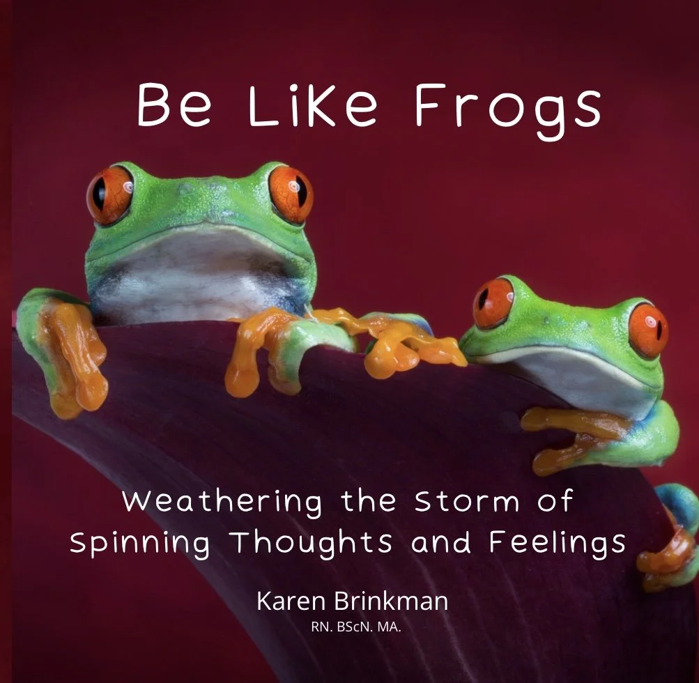 Book cover titled 'Be Like Frogs: Weathering the Storm of Spinning Thoughts and Feelings' by Karen Brinkman, featuring two vivid green frogs with orange eyes on a dark purple leaf against a reddish background.