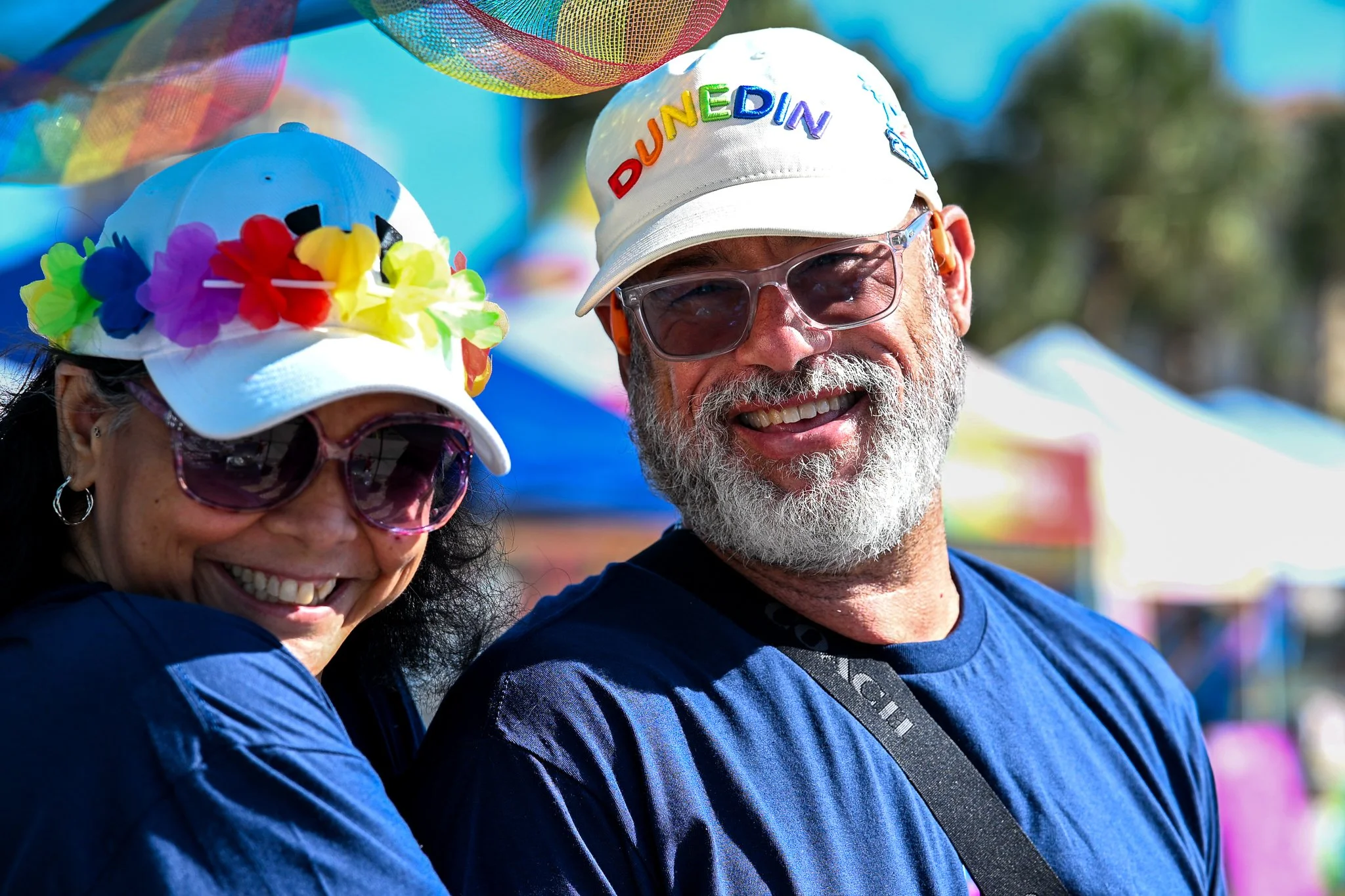 Two smiling volunteers at a community event in St. Petersburg, FL for LGBTQ Pride Month