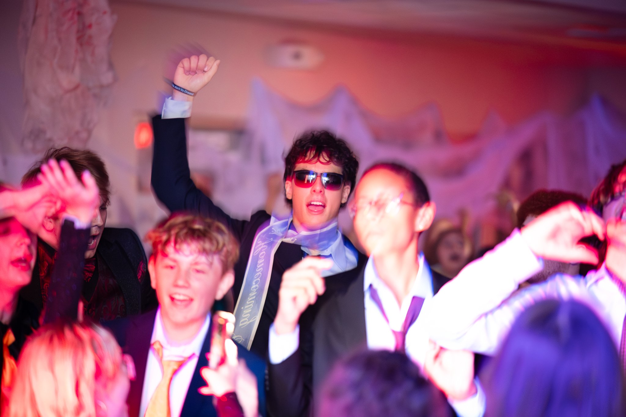 High school students dancing at homecoming during event photography session 