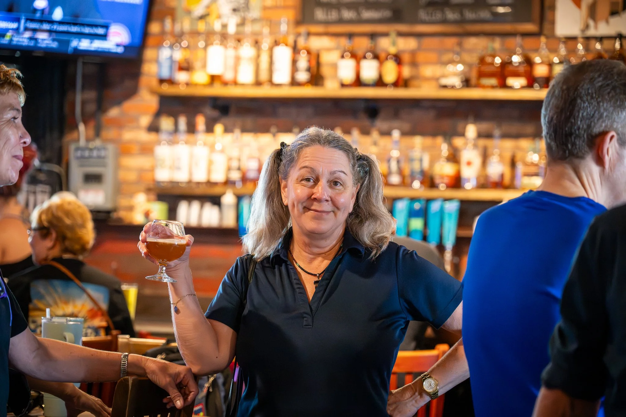 Woman enjoying a beverage at a non-profit community event in St. Petersburg 