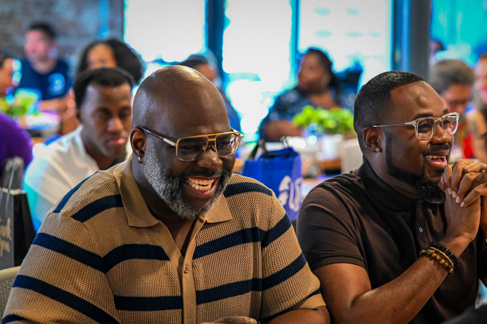 Attendees laughing during a candid moment at a special event in Tampa, FL 