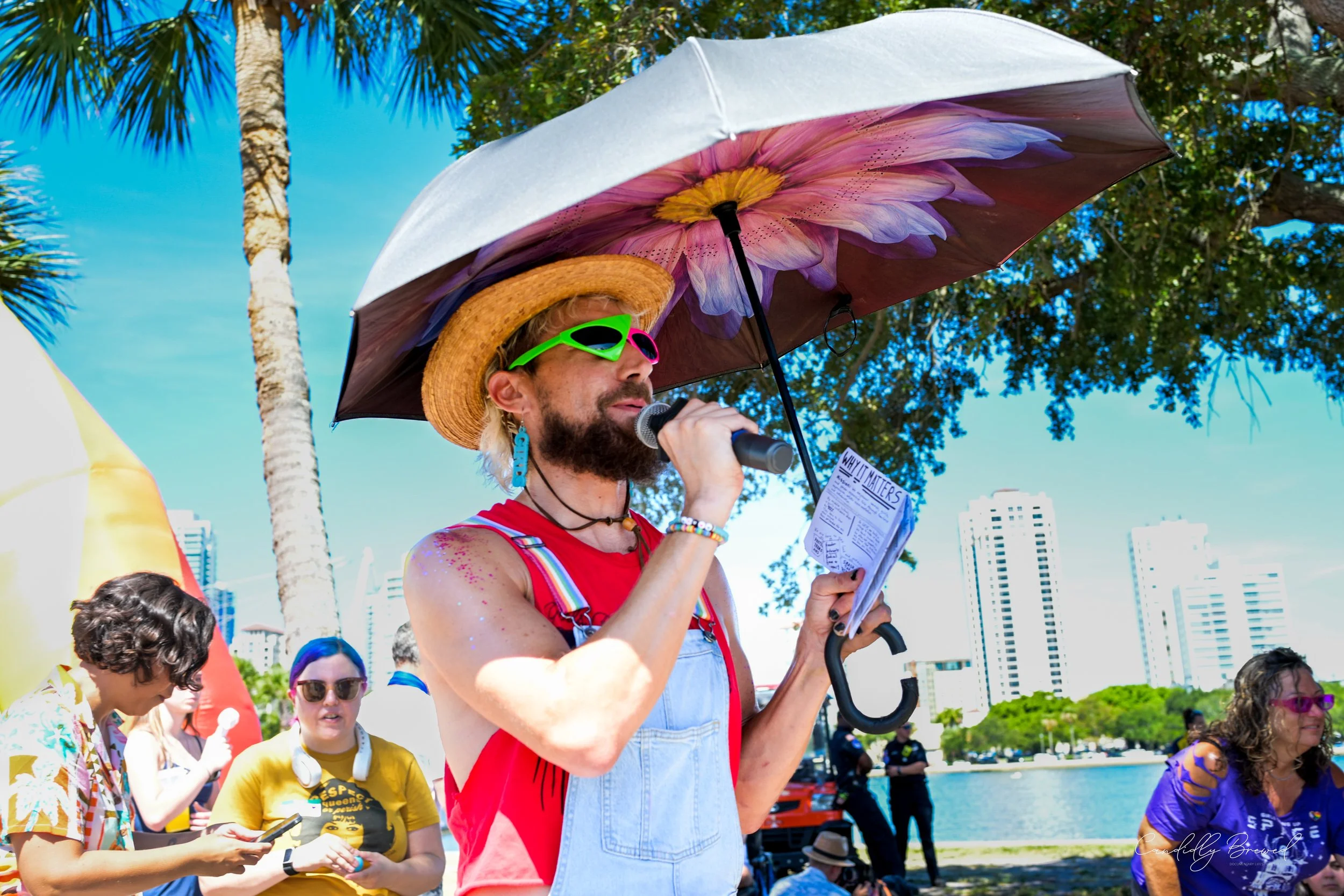 Volunteer on a microphone at a community event in St. Petersburg, FL for LGBTQ Pride Month