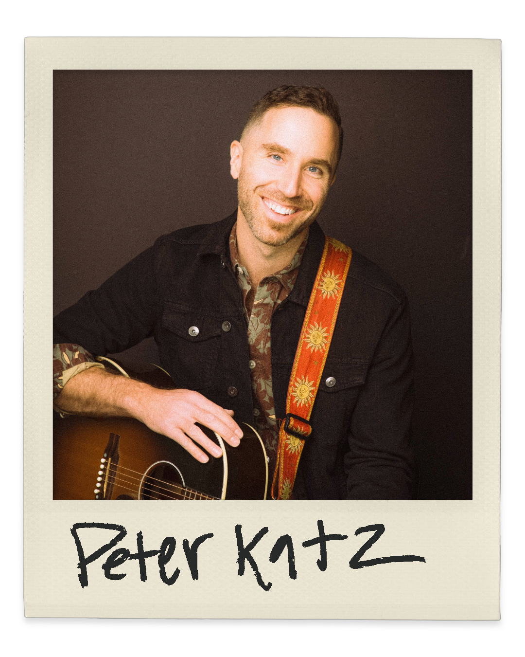 Polaroid portrait of Peter Katz smiling and holding a guitar with handwritten label.