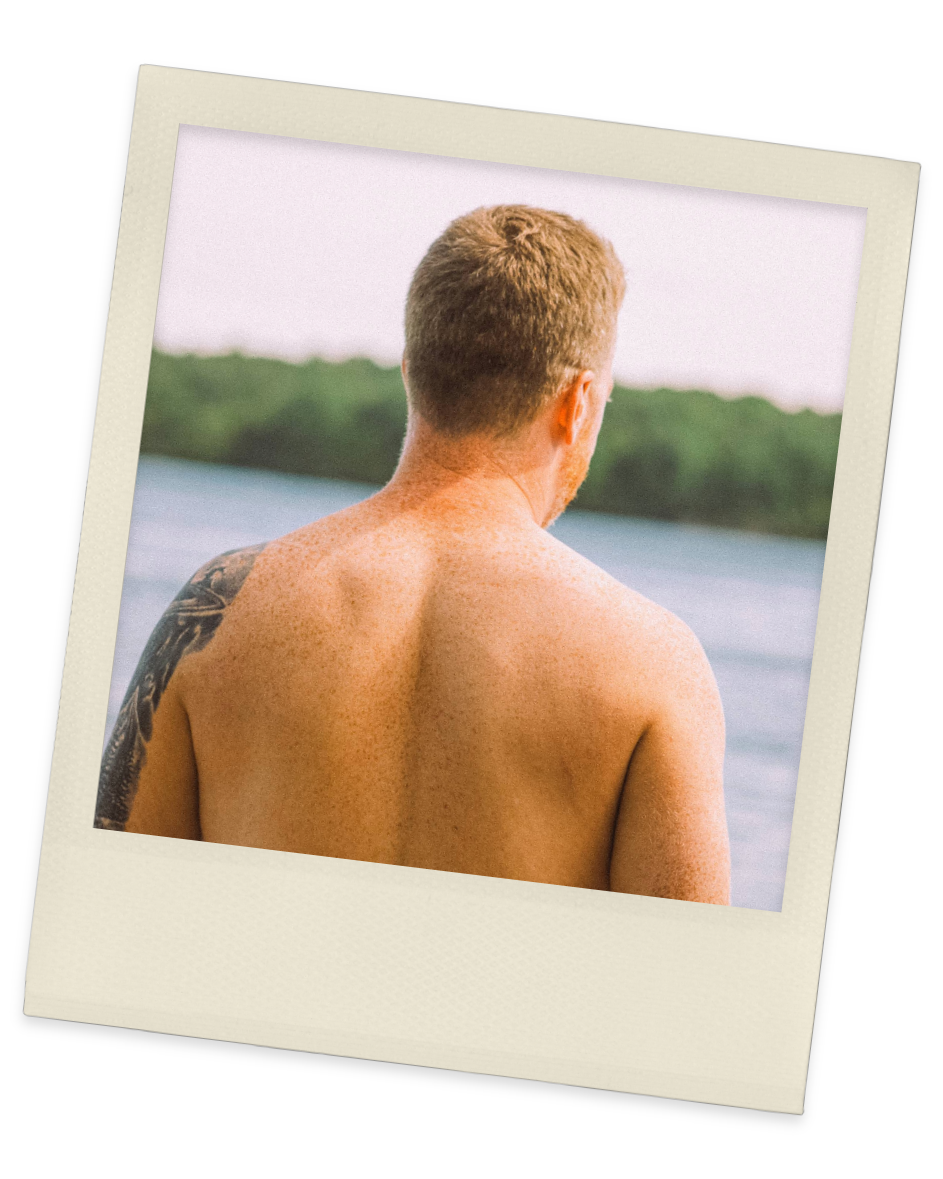 Vintage-style Polaroid shows man facing lake