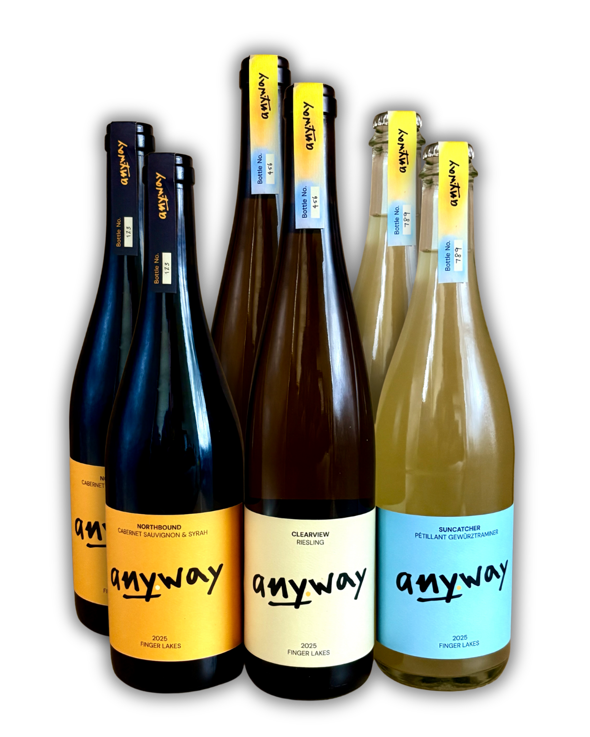 Six bottles of Anyway Wine's 2025 vintage featuring different labels and colors. From left to right, 2 bottles of each: a red wine blend called Northbound, a Riesling called Clearview, and a sparkling Gewüztraminer called Suncatcher.