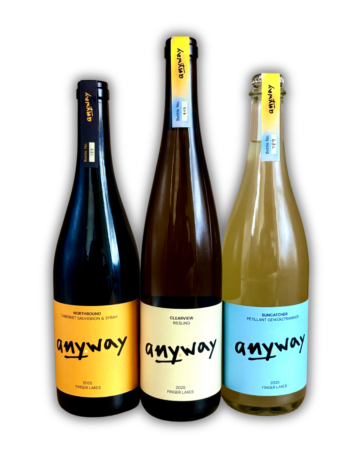 Three bottles of Anyway Wine's 2025 vintage featuring different labels and colors. From left to right: a red wine blend called Northbound, a Riesling called Clearview, and a sparkling Gewüztraminer called Suncatcher.